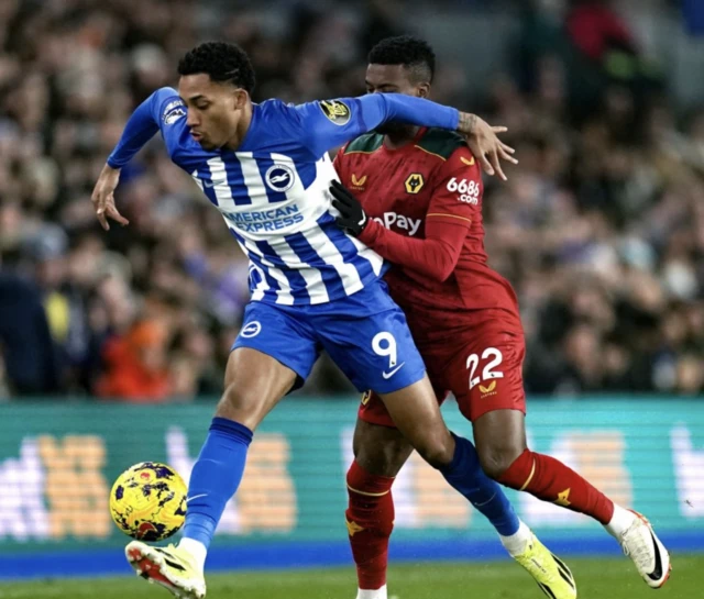 Joao Pedro and Wolverhampton Wanderers' Nelson Semedo (right) battle for the ball