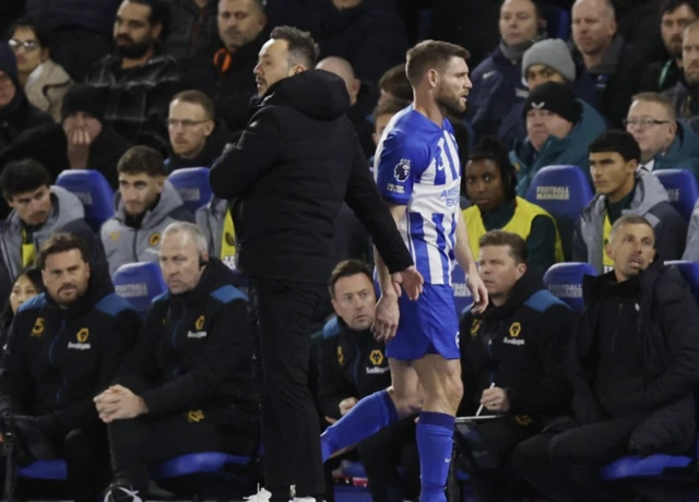 James Milner walks past Roberto Di Zerbi as he is substituted