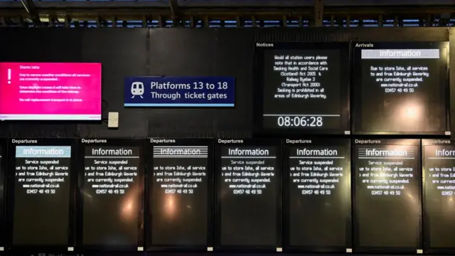 Information boards at Edinburgh Waverly station at 08:06 show disruption to trains in Scotland