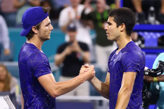 Miomir Kecmanovic and Carlos Alcaraz shake hands at the net