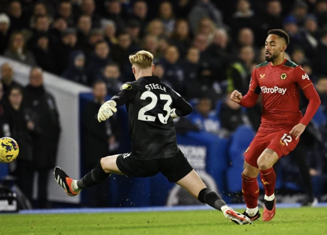 Matheus Cunha touches the ball past Jason Steele