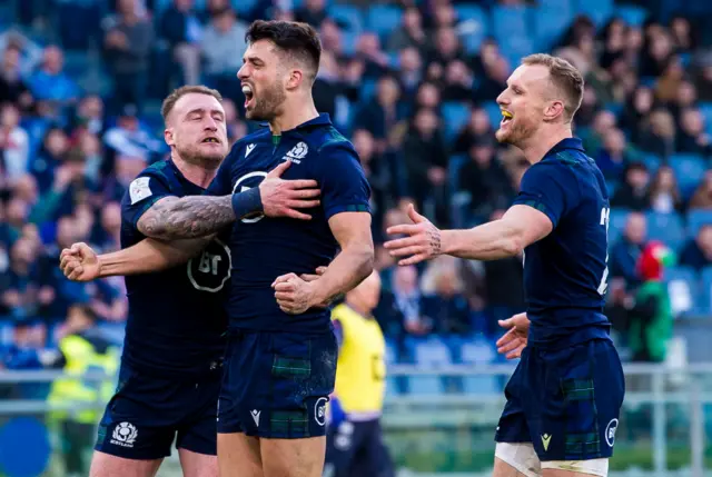 Scotland's Adam Hastings (centre) celebrates his try with Stuart Hogg (left) and Rory Hutchinson during the Guinness Six Nations match between Italy and Scotland, at the Stadio Olimpico, on February 22, 2020, in Rome, Italy.