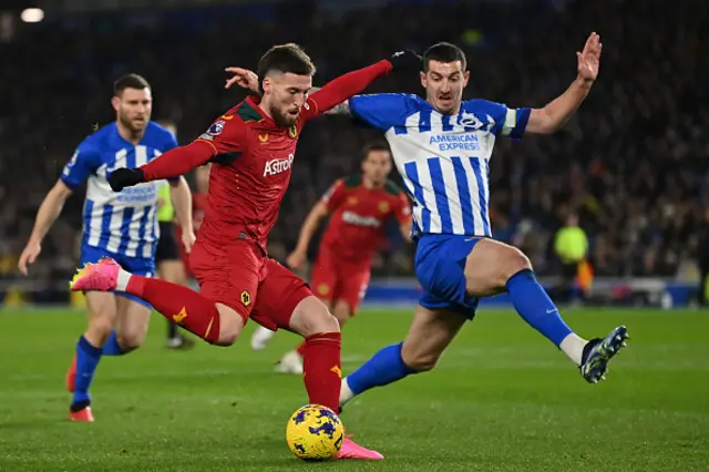 Matt Doherty takes a shot with Lewis Dunk blocking the ball