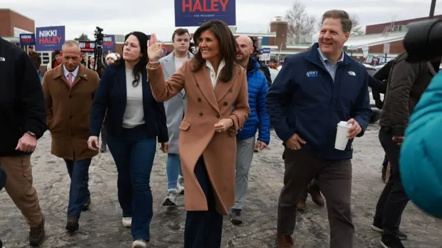 Republican presidential candidate, former U.N. Ambassador Nikki Haley is joined by New Hampshire Gov. Chris Sununu as they visit a polling location at Winnacunnet High School to greet voters on January 23, 2024, in Hampton, New Hampshire. voters are heading to the polls as the state holds its primary