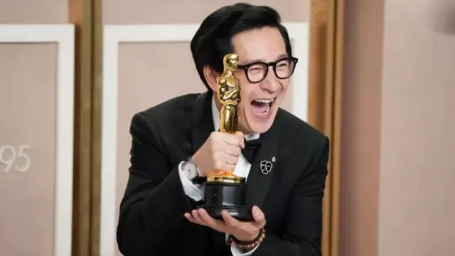 Ke Huy Quan holding his Oscar in 2023