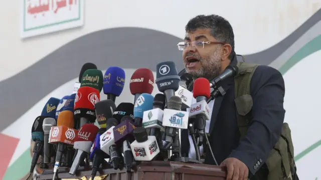 Mohammed Ali al-Houthi in front of microphones speaking