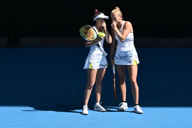 Storm Hunter and Katerina Siniakova in discussion covering their mouths on court