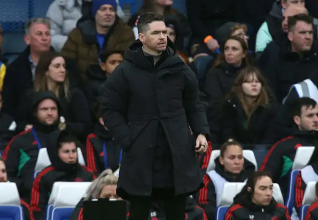 Marc Skinner stands on the touchline at Stamford Bridge.