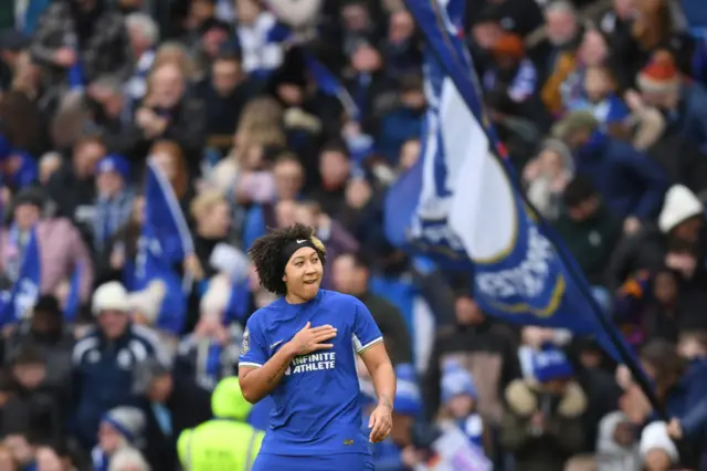 Lauren James pats the Chelsea crest on her shirt in celebration of her hat-trick.