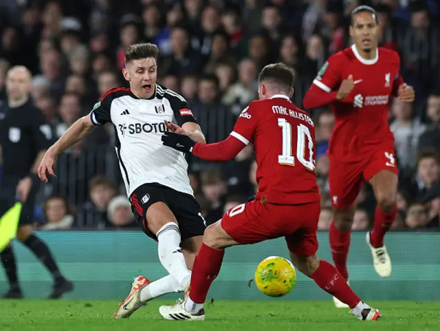 Tom Cairney vies with Liverpool's midfielder Alexis Mac Allister