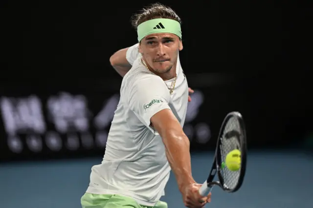 Alexander Zverev stretches to hit a backhand volley