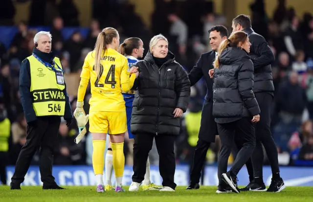 Hannah Hampton and Emma Hayes shake hands on the pitch at full time.