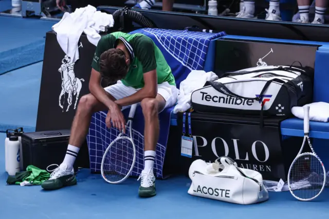 Daniil Medvedev slouches in his chair in exhaustion