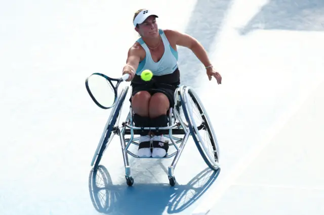 Lucy Shuker stretches to hit a forehand shot