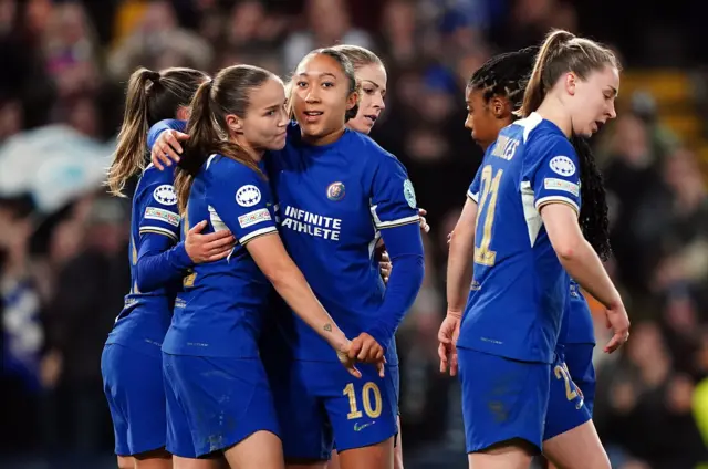 Chelsea players celebrate with Guro Reiten after she opened the scoring v Madrid.