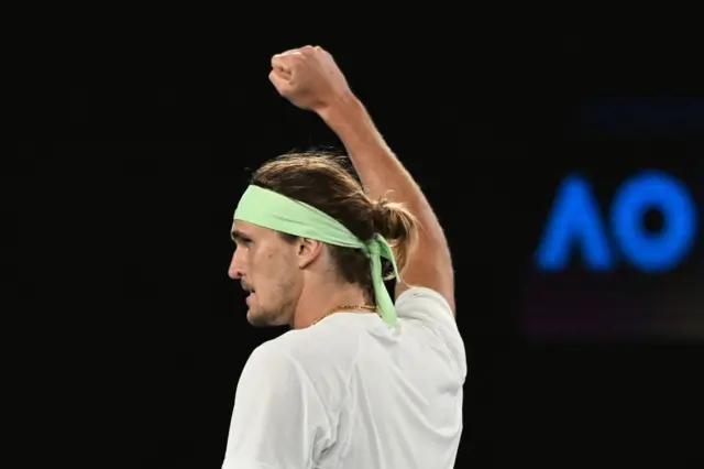 Alexander Zverev raises his fist to the sky in celebration