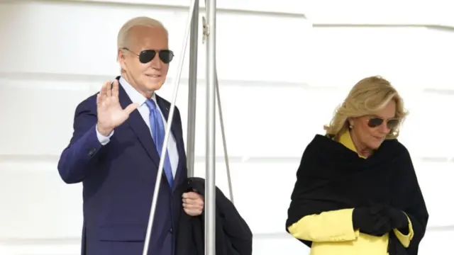 Joe Biden, left, and First Lady Jill Biden walk on the South Lawn of the White House before boarding Marine One in Washington, DC