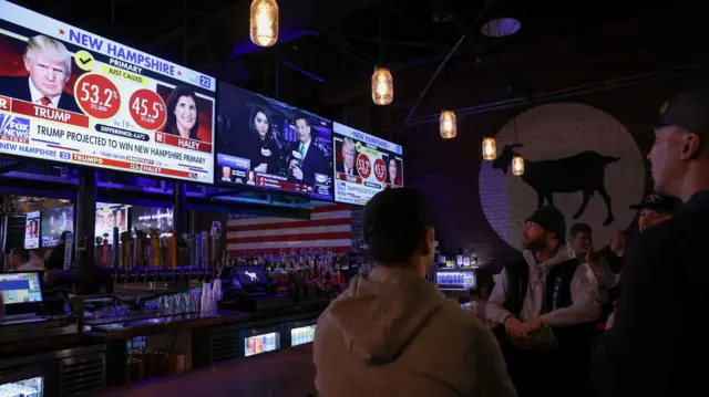 People watch TV at a bar in New Hampshire