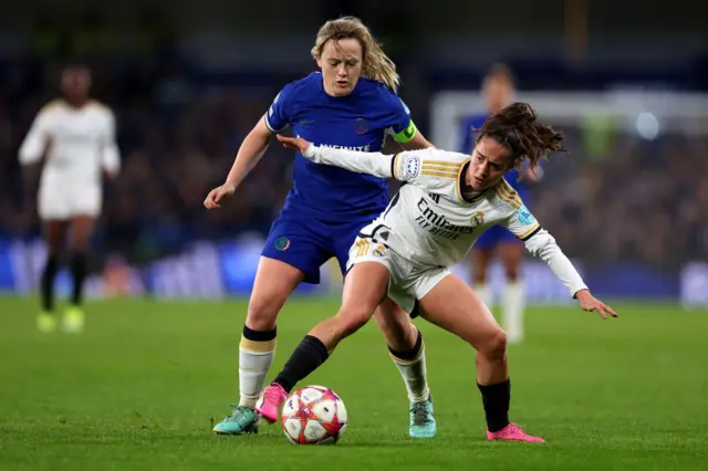 Cuthbert battles Oroz for the ball in the midfield.