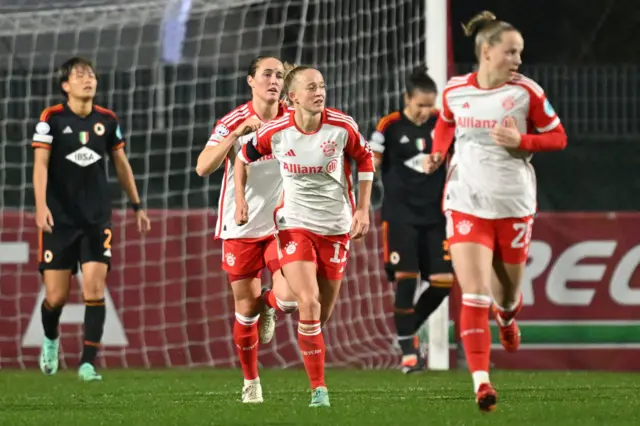 Lea Schuller runs back to kick off with teammates after scoring for Bayern.