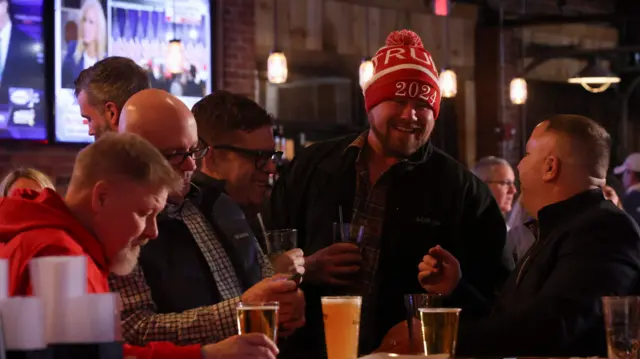 People drink beer watching the New Hampshire primary