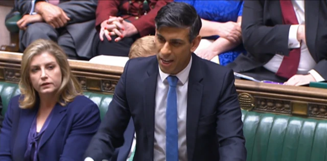 A close up of Sunak standing to speak in the House of Commons