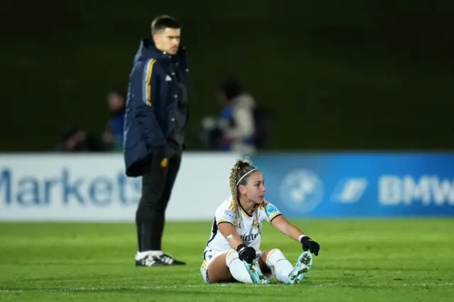 Athenea del Castillo sits on the floor after Real Madrid's UWCL elimination.