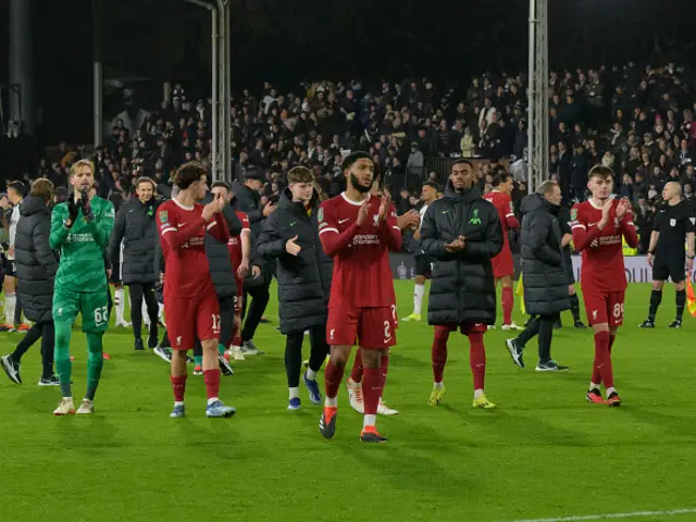 Liverpool players applaud the fans