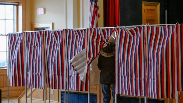 A voter enters a voting booth to fill out a ballot to vote in New Hampshire's first-in-the-nation U.S. presidential primary election at the Medallion Opera House in Gorham, New Hampshire, U.S., January 23, 2024.