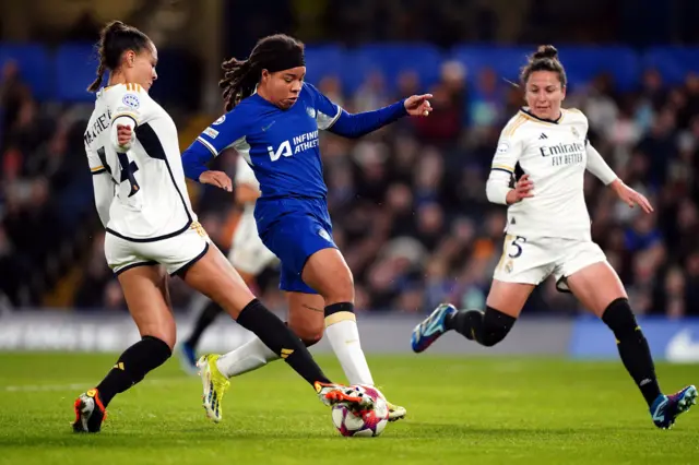 Mia Fishel challenges two Madrid players for the ball.