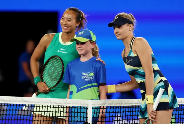 Qinwen Zheng and Dayana Yastremska pose with girl at the net for photo