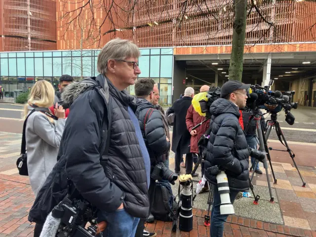 Media assemble outside court