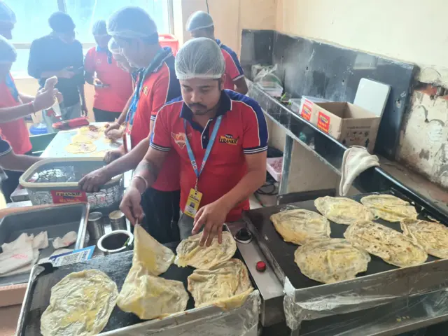 A worker prepares food during the India-England Test in Hyderabad