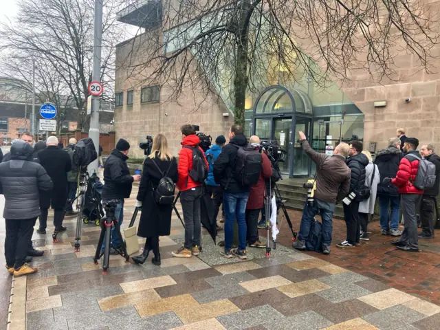 Media assemble outside court