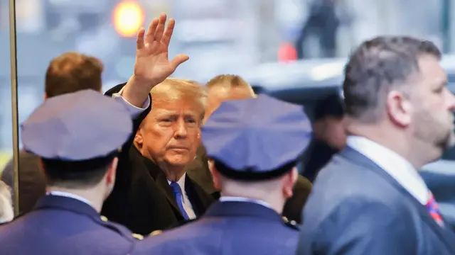 Donald Trump waves to cameras in New York