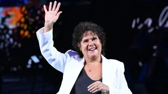 Australia's former tennis player Evonne Goolagong Cawley gestures to the crowd before the start of the women's singles semi-final match between USA's Coco Gauff and Belarus' Aryna Sabalenka on day 12 of the Australian Open tennis tournament in Melbourne