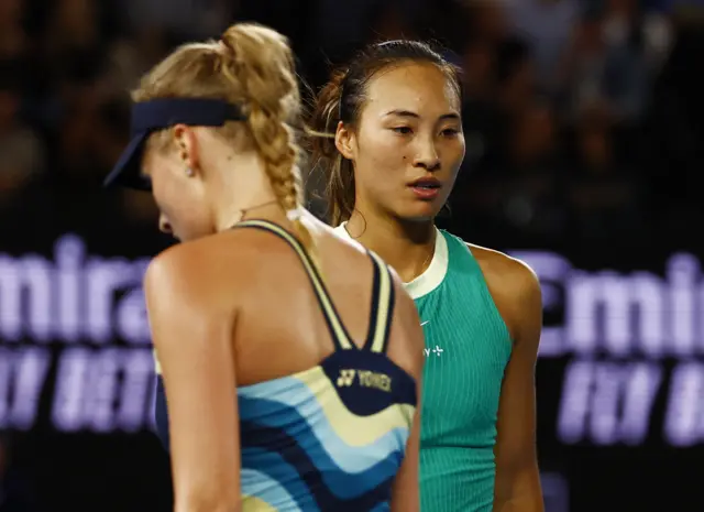 Qinwen Zheng walks past Dayana Yastremska