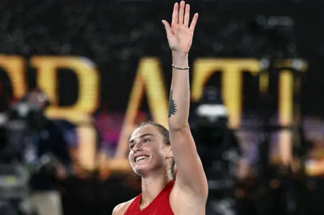 Aryna Sabalenka waves to the crowd in celebration