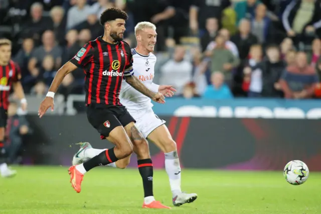 Philip Billing (left) of Bournemouth challenges Jay Fulton of Swansea