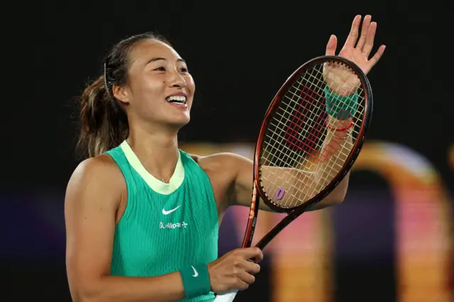 Qinwen Zheng claps her racquet in celebration