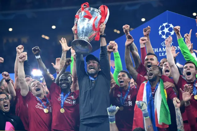 Jurgen Klopp holds up the Champions League trophy