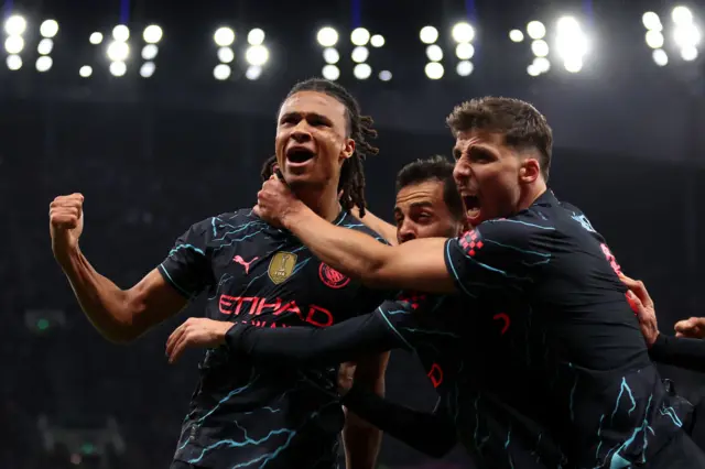 Nathan Ake celebrates scoring with his Manchester City teammates