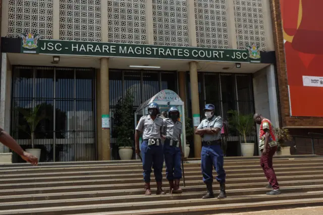 Police officers stand guard the entrance to the Magistrate court on April 6, 2021 in Harare, Zimbabwe