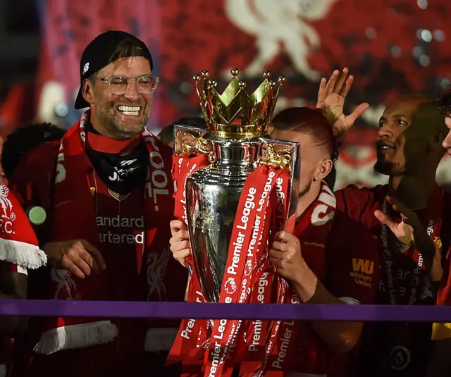 Jurgen Klopp holds the Premier League trophy