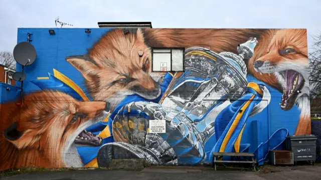 A mural showing foxes with the FA Cup