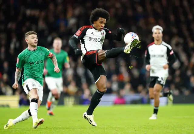 Willian tries to control the ball in mid air as Trippier watches on.