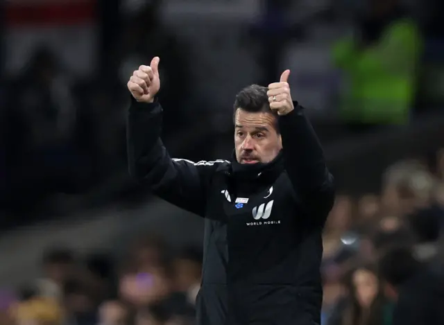 Marco Silva holds thumbs up to his players from the touchline.