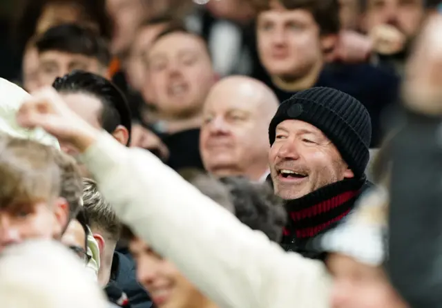 Alan Shearer stands beaming among the travelling Newcastle fans.