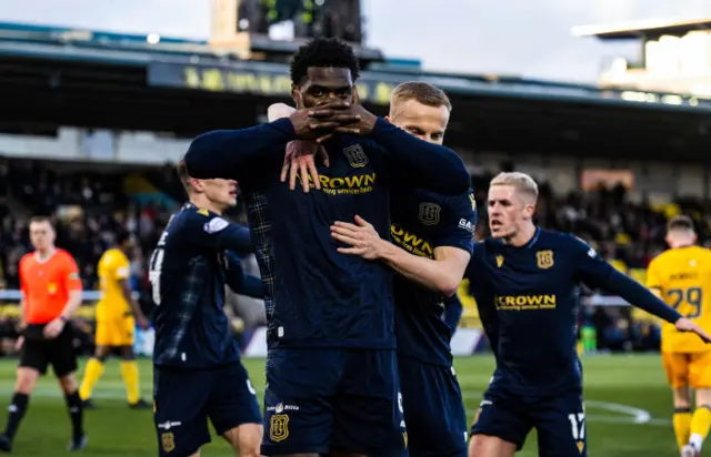 Amadou Bakayoko celebrating his goal at Tony Macaroni Arena with a signature celebration - locked hands covering face.