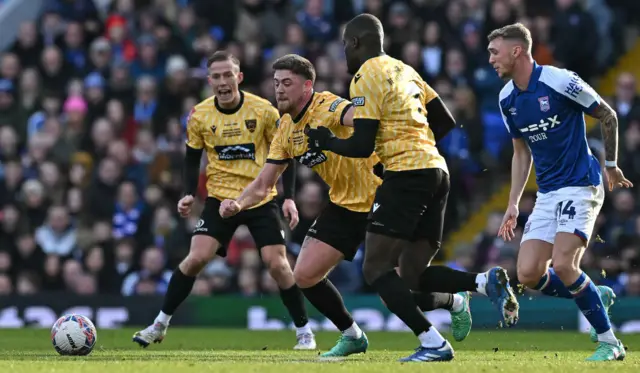 Maidstone players crowd out a run from an Ipswich forward to regain the ball.